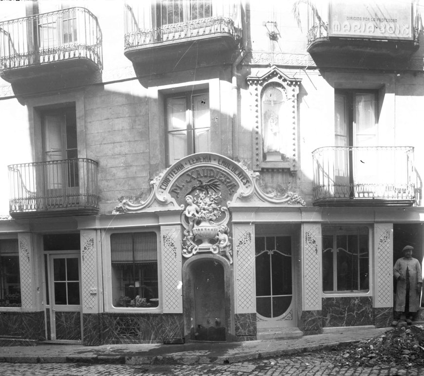 Vista parcial de Can Xaudiera amb Sadurní Brunet i el seu fill Joan al costat, 1922 (ACGAX. Fons Sadurní Brunet Pi. Autor Sadurní Brunet. Codi atribuït 15.14)